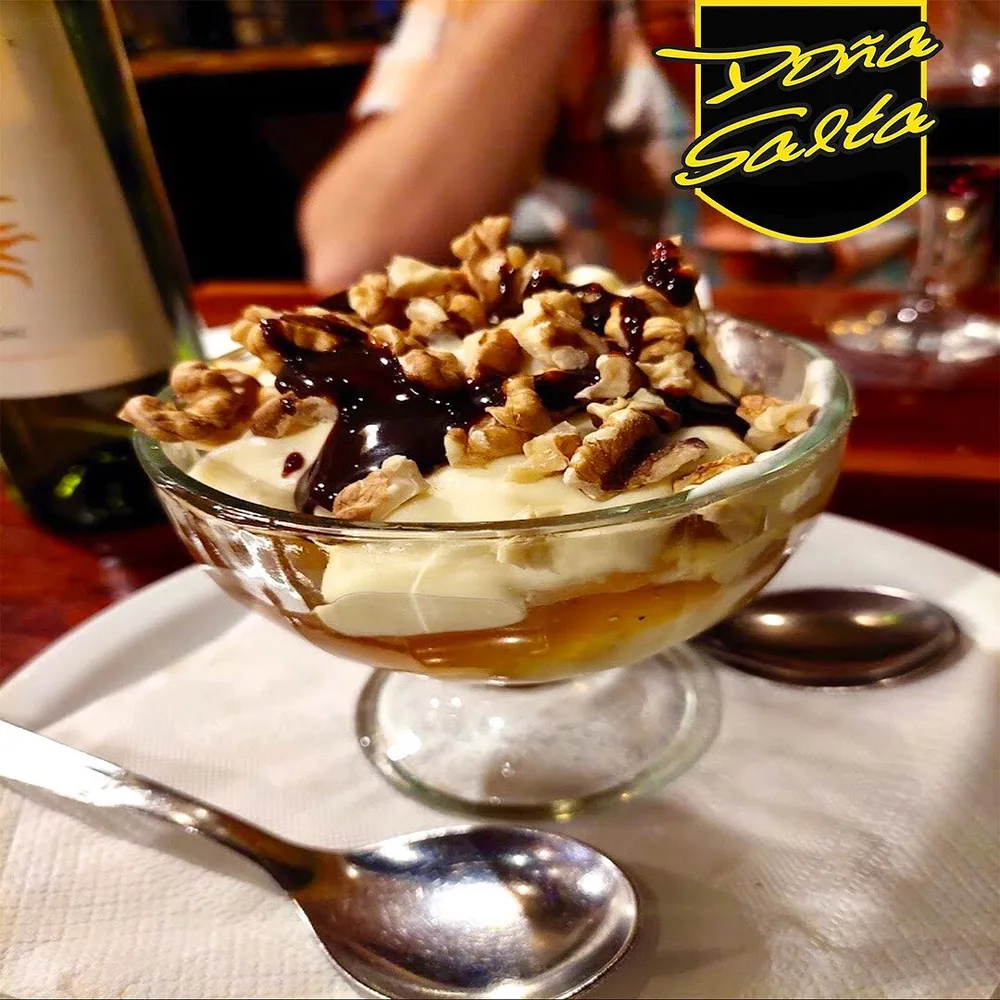 Copa de postre con helado, nueces y chocolate