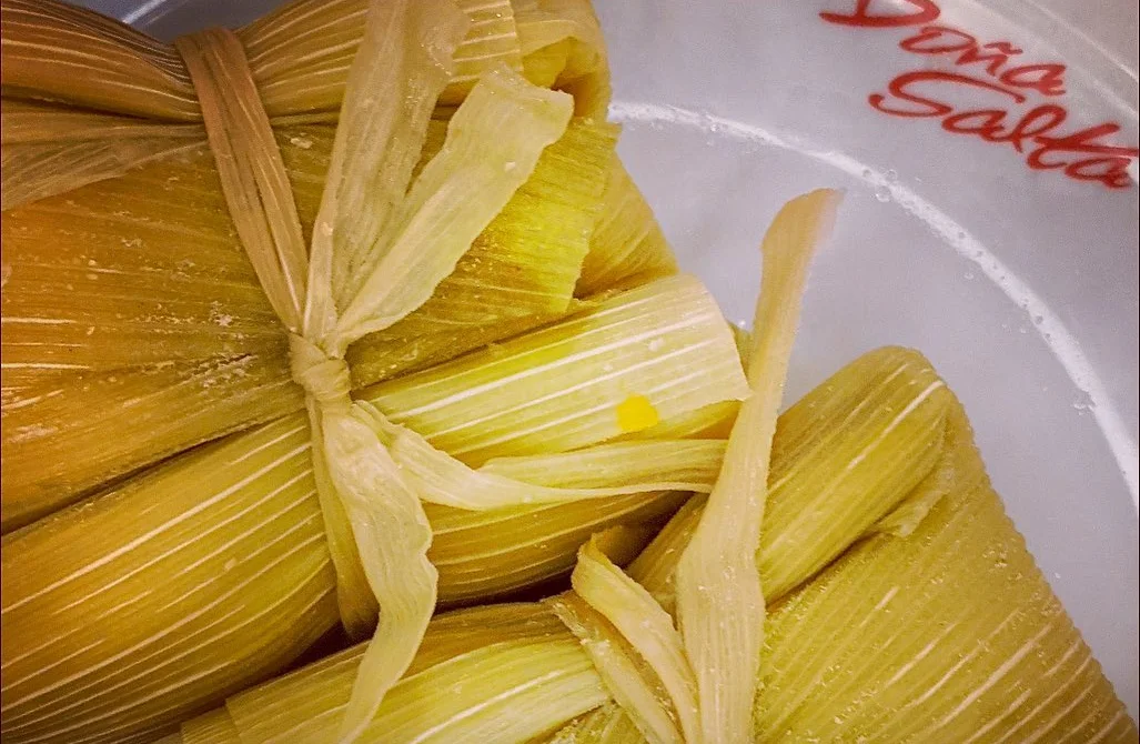 Tamales atados en chala sobre plato de Doña Salta